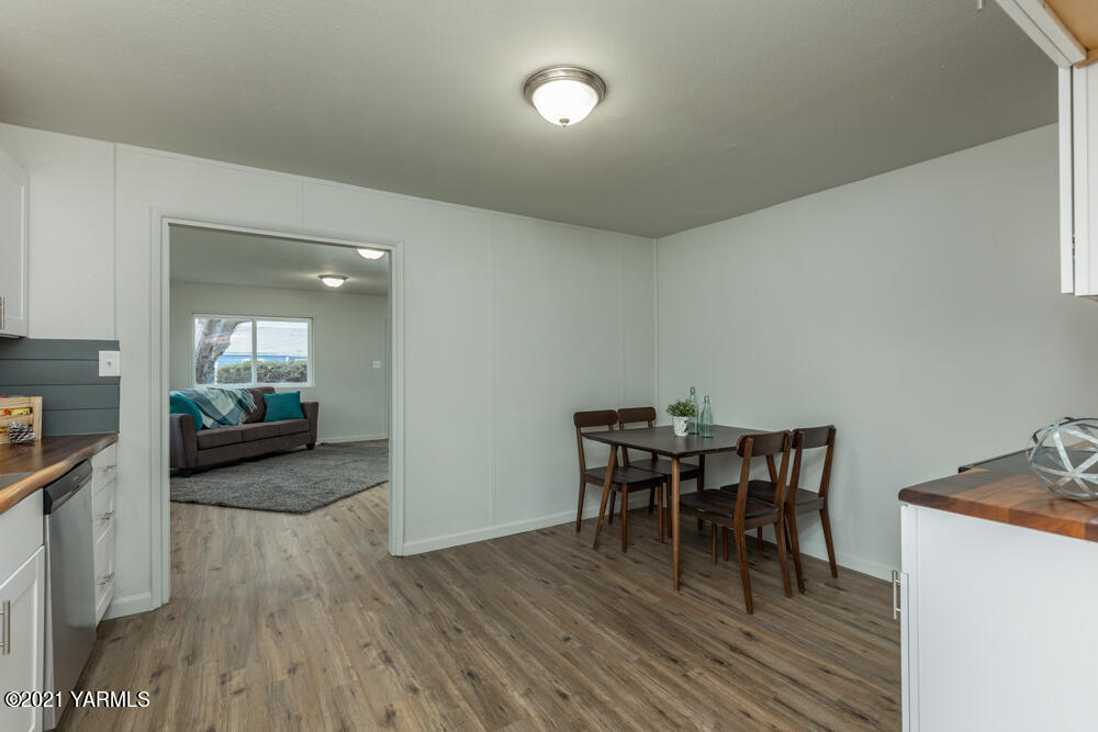 307 Nealy Road Grandview, WA 98930 - Photo 8 of 20 a view of a dining room with furniture and wooden floor