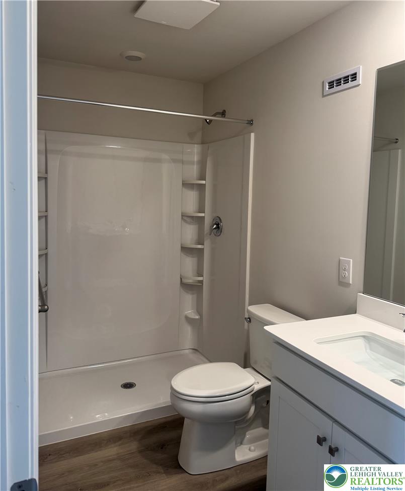 1168 Martin Road Breinigsville, PA 18031 - Photo 3 of 11 Modern full bathroom featuring a stand-up shower, sleek vanity, and durable wood-look flooring.