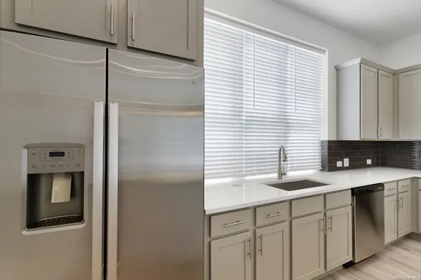 a kitchen with a sink and a refrigerator
