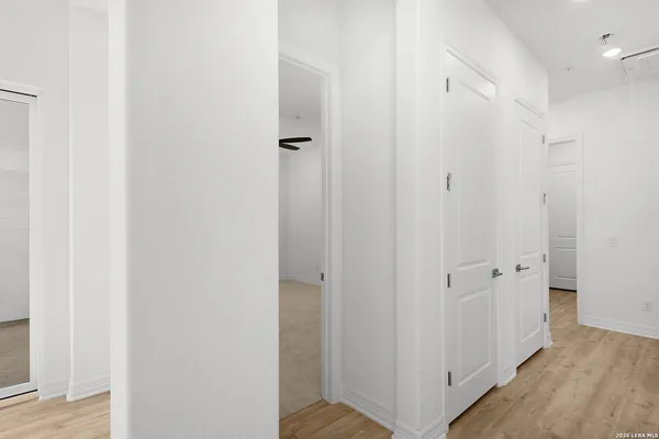 a view of a hallway with wooden floor