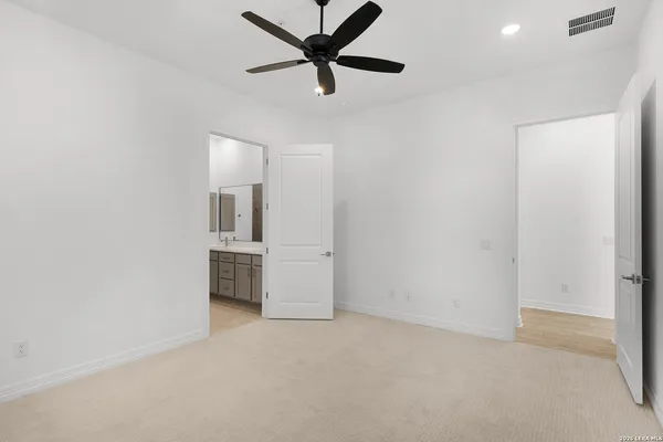 an empty room with a empty space and a ceiling fan
