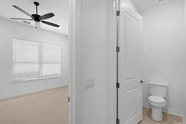 a bathroom with a toilet and a shower