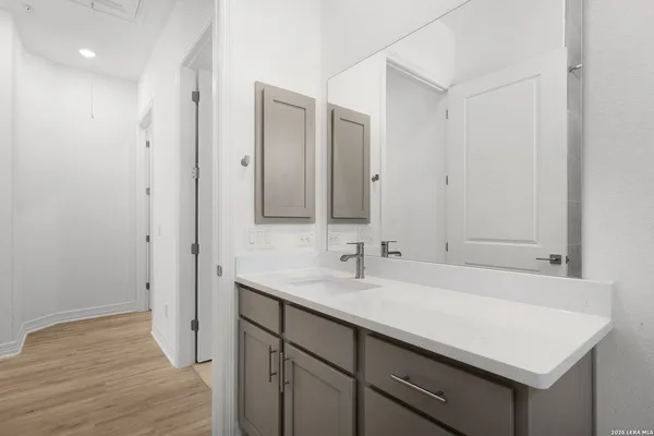 an empty room with a window and a ceiling fan