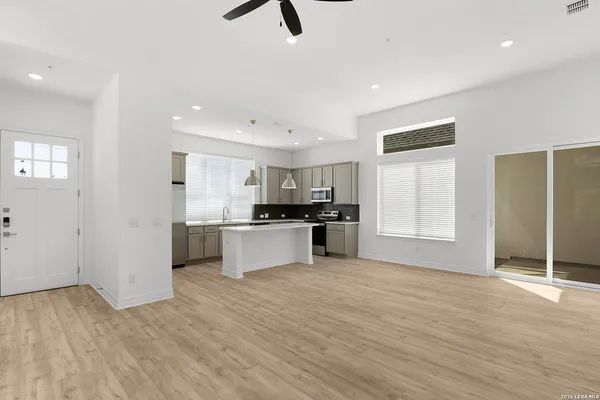 a view of kitchen with refrigerator and microwave