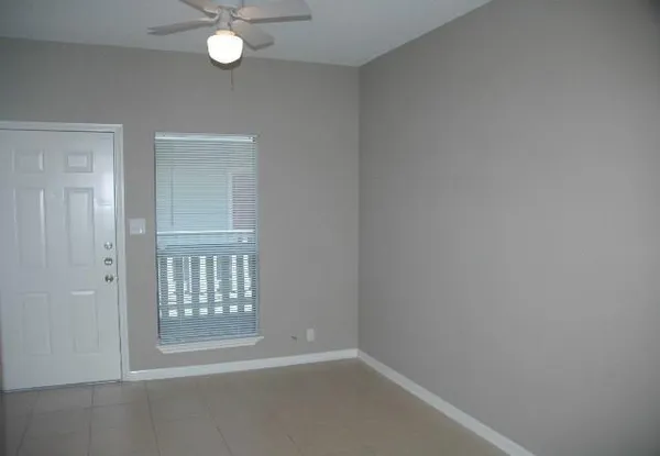 an empty room with windows and entrance