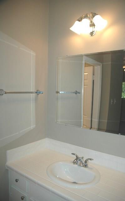 3206 King Street, Unit 202 Austin, TX 78705 - Photo 6 of 9 a bathroom with a sink and a mirror