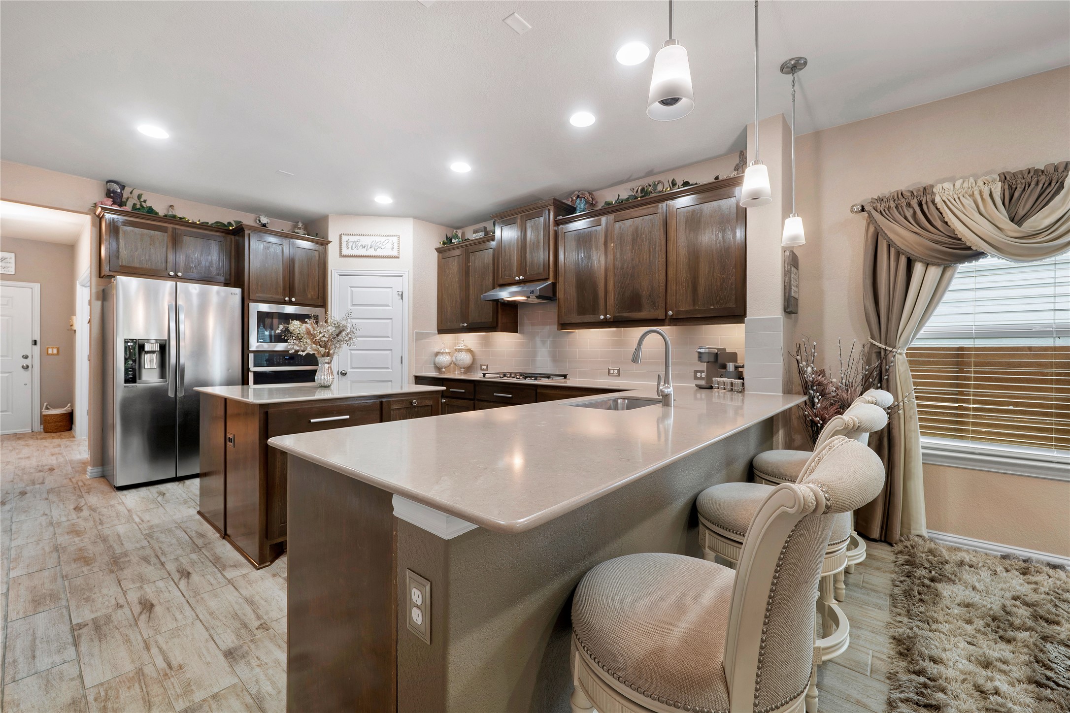 8721 Sikes Way Austin, TX 78747 - Photo 11 of 33 a kitchen with stainless steel appliances granite countertop a sink a stove and a refrigerator