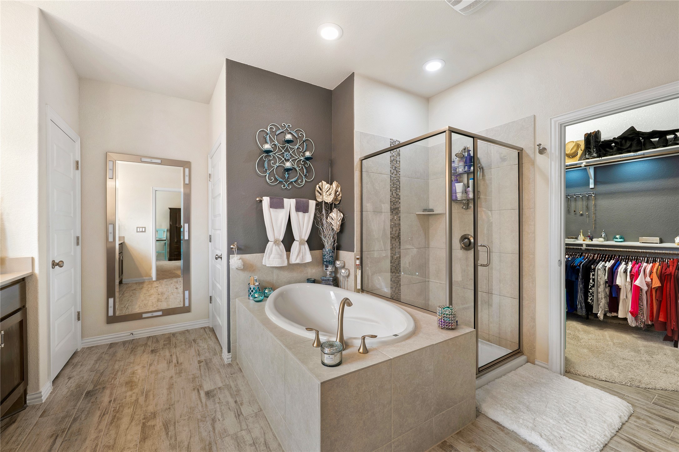 8721 Sikes Way Austin, TX 78747 - Photo 18 of 33 a bathroom with a tub a mirror and shower