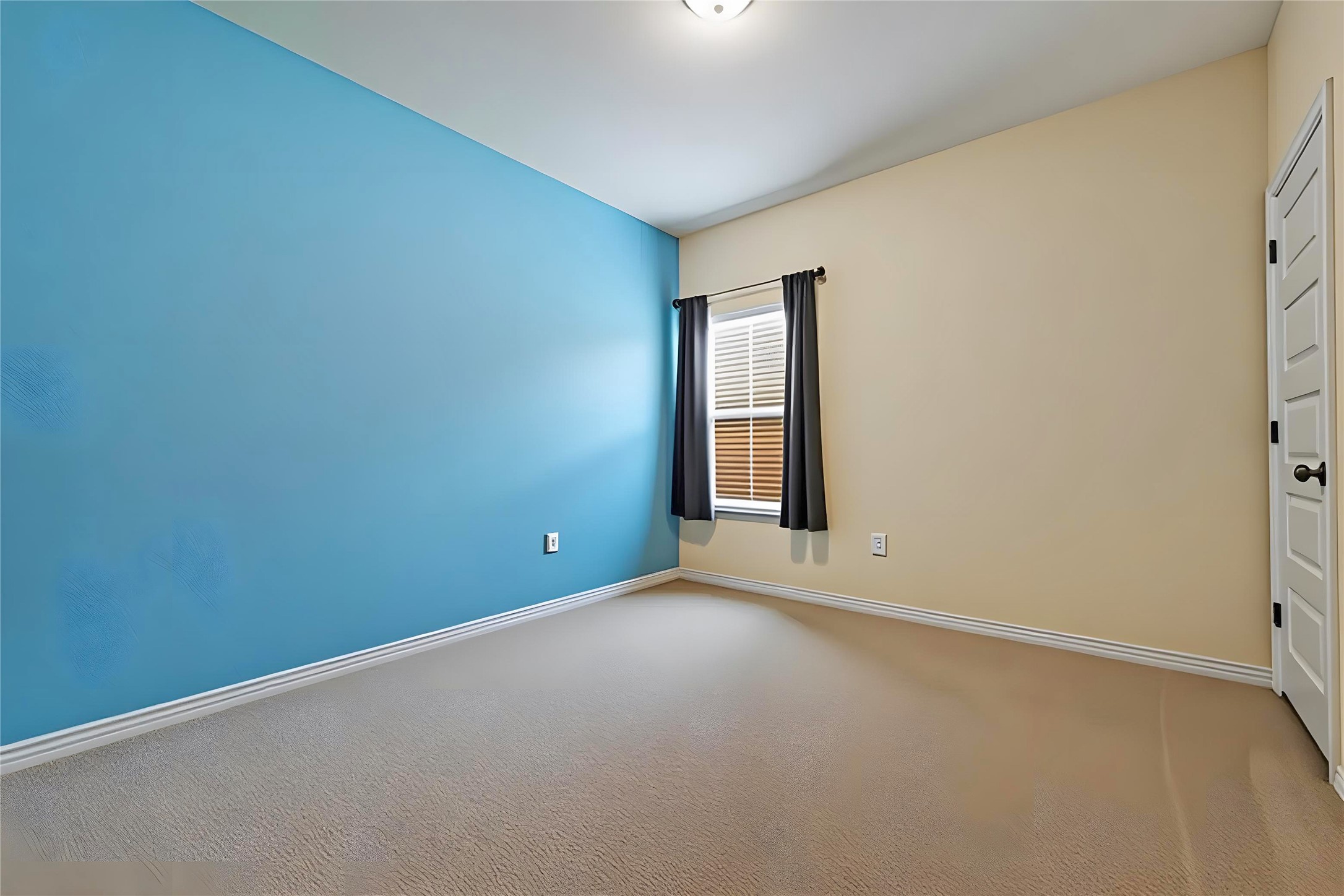 8721 Sikes Way Austin, TX 78747 - Photo 22 of 33 Bedroom #2 featuring a prominent blue accent wall and neutral carpeting