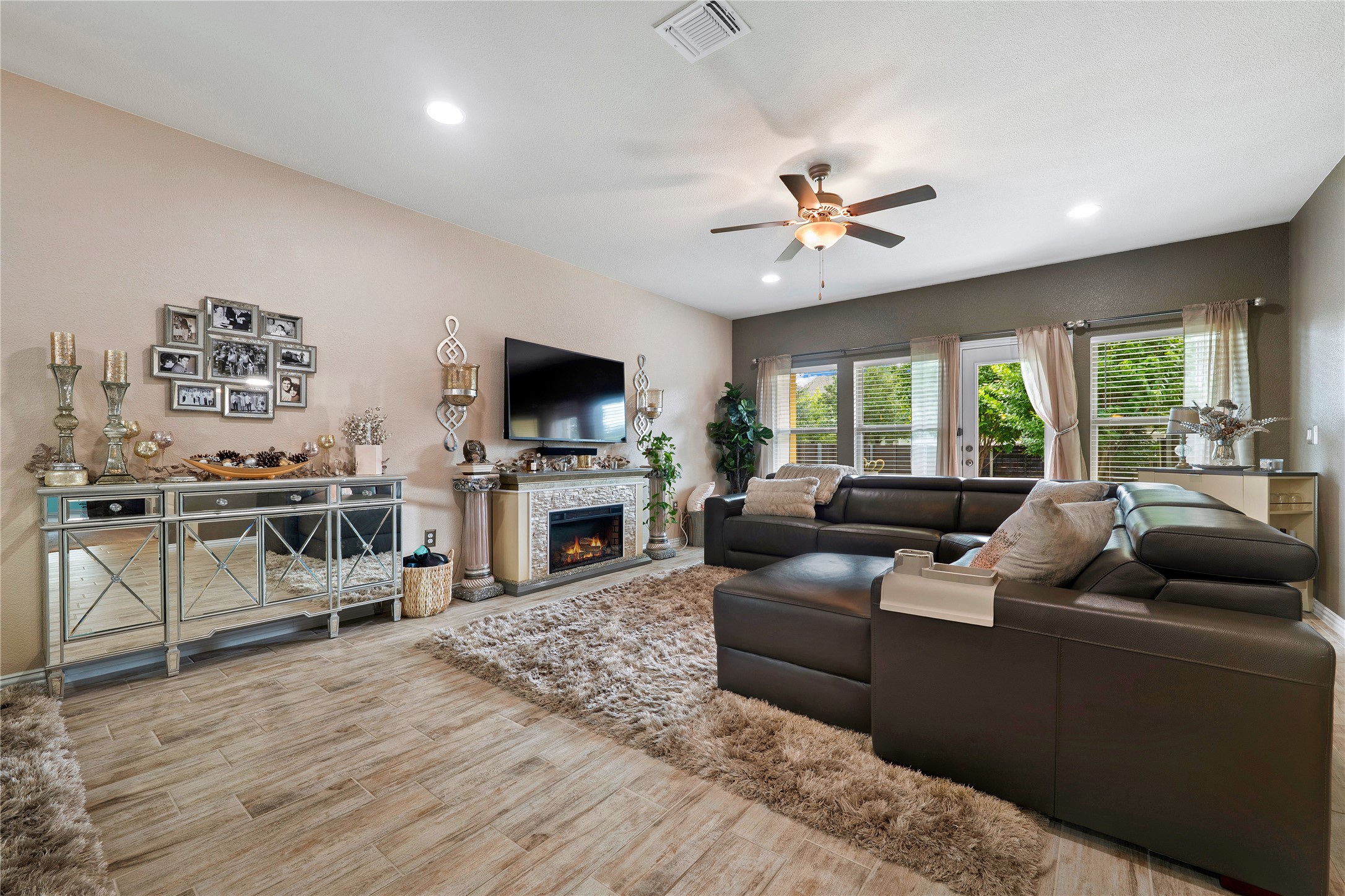 8721 Sikes Way Austin, TX 78747 - Photo 6 of 33 a living room with furniture kitchen view and a fireplace
