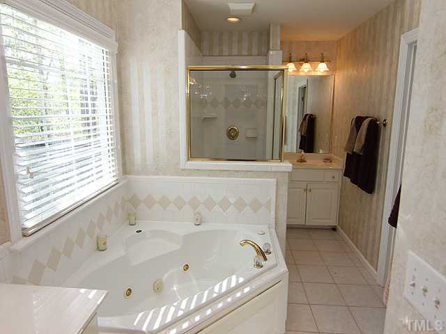 9404 Stone Mountain Road Raleigh, NC 27613 - Photo 11 of 25 Master Bathroom Features DUAL Sink Areas, Separate Whirlpool Tub and Shower and a Skylight! A Great Place to Retreat After a Long Day! Master Bath/Spa