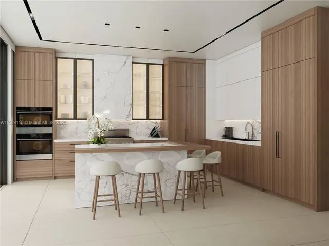 a kitchen with a sink and chairs