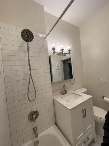 a bathroom with a sink mirror and toilet