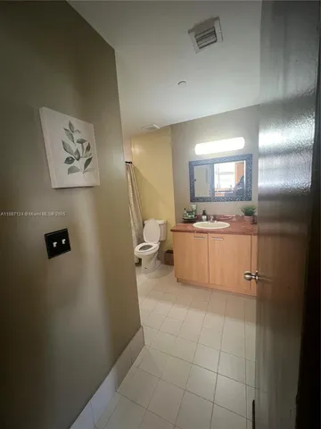 a bathroom with a granite countertop sink a mirror and a shower