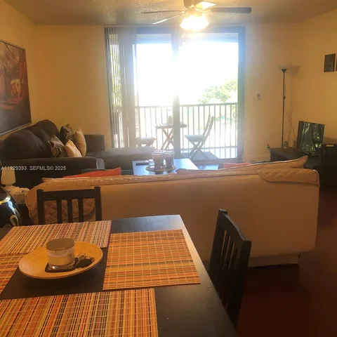 a living room with a couch and large windows