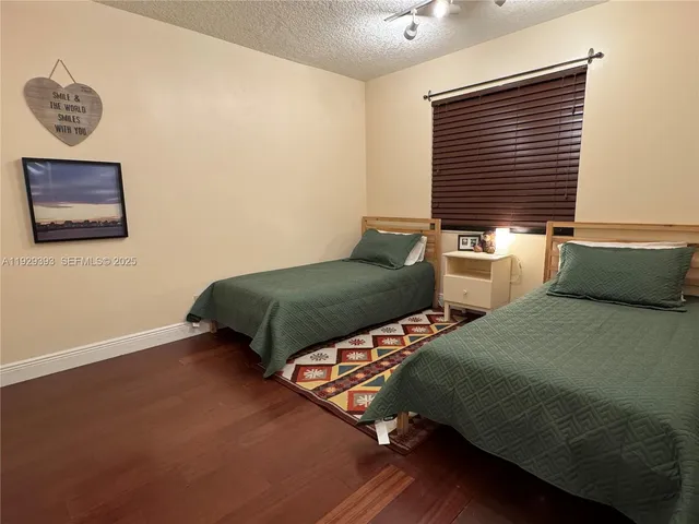 a bedroom with two beds and a window