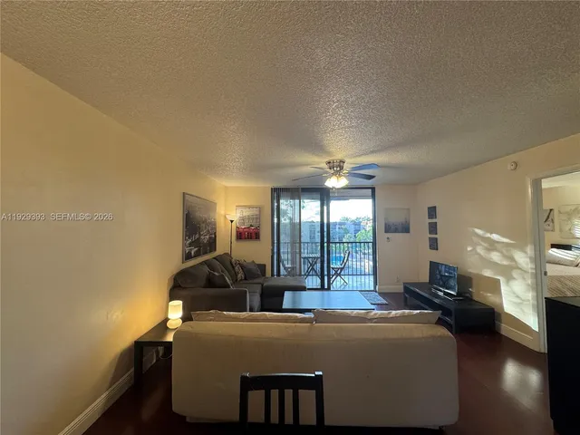 a living room with a couch and a potted plant