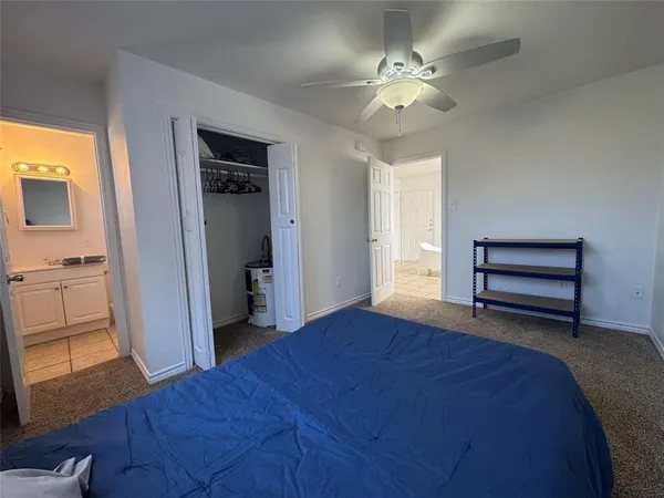 a room with a table and a ceiling fan