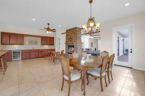 a view of a dining room with furniture and chandelier