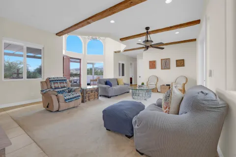 a living room with furniture and a chandelier