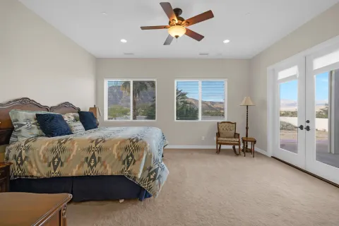a bedroom with a bed and a chandelier