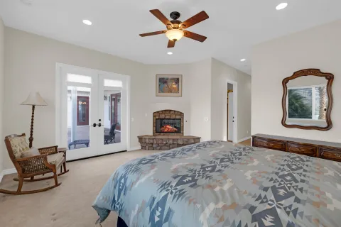 a bedroom with a bed and a large mirror