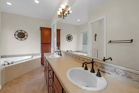a bathroom with a sink a mirror and a bathtub