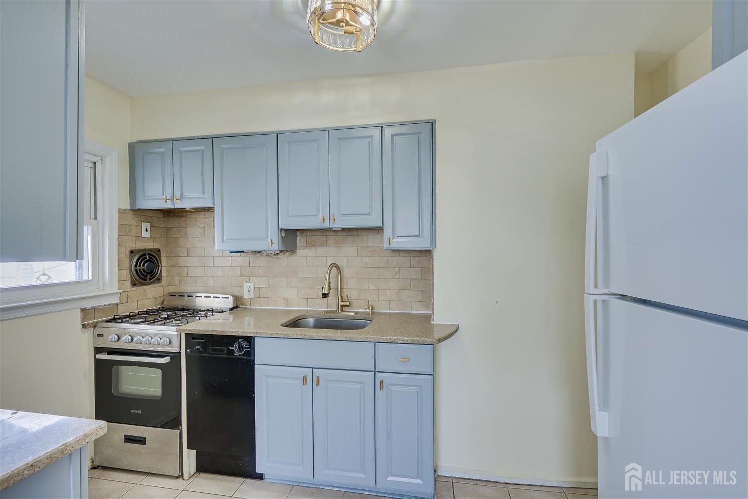 1 Coolidge Avenue Edison, NJ 08837 - Photo 12 of 27 a kitchen with a sink stove and cabinets