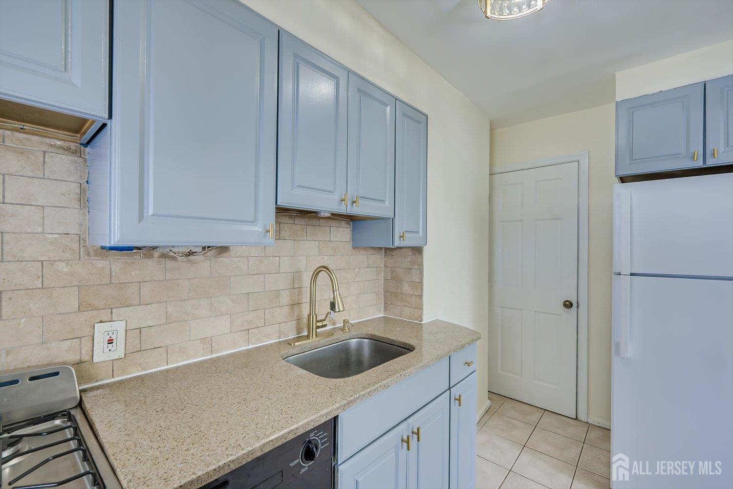 1 Coolidge Avenue Edison, NJ 08837 - Photo 17 of 27 a kitchen with stainless steel appliances a sink a refrigerator and cabinets