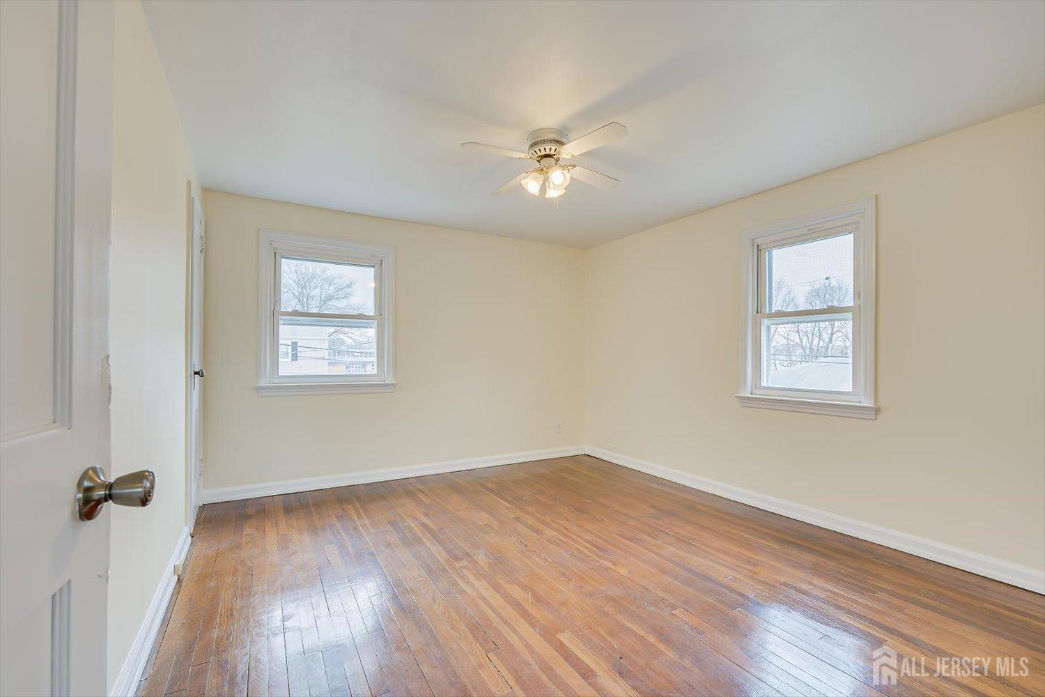 1 Coolidge Avenue Edison, NJ 08837 - Photo 18 of 27 a view of a room with wooden floor and a ceiling fan
