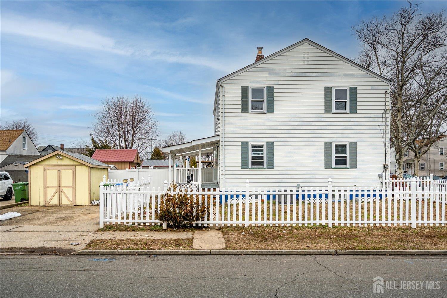1 Coolidge Avenue Edison, NJ 08837 - Photo 21 of 27 a front view of a house with a fence