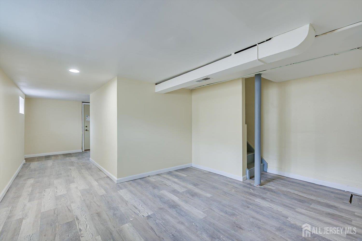 1 Coolidge Avenue Edison, NJ 08837 - Photo 23 of 27 a view of an empty room with wooden floor