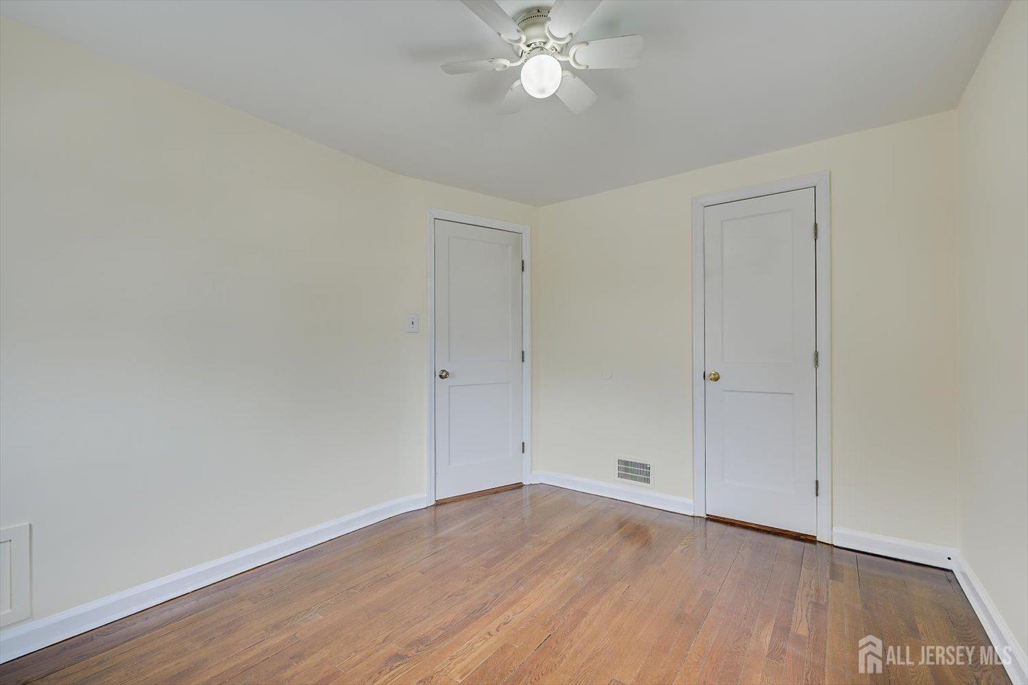 1 Coolidge Avenue Edison, NJ 08837 - Photo 24 of 27 a view of an empty room with wooden floor
