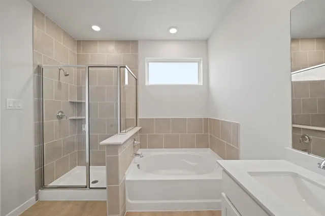 a bathroom with a bathtub and a shower