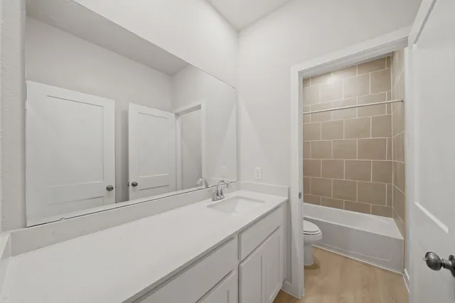 a bathroom with a shower sink and bathtub