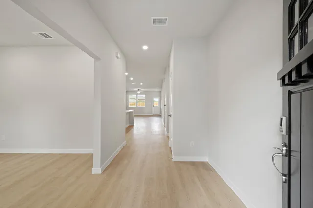 a view of hallway with wooden floor