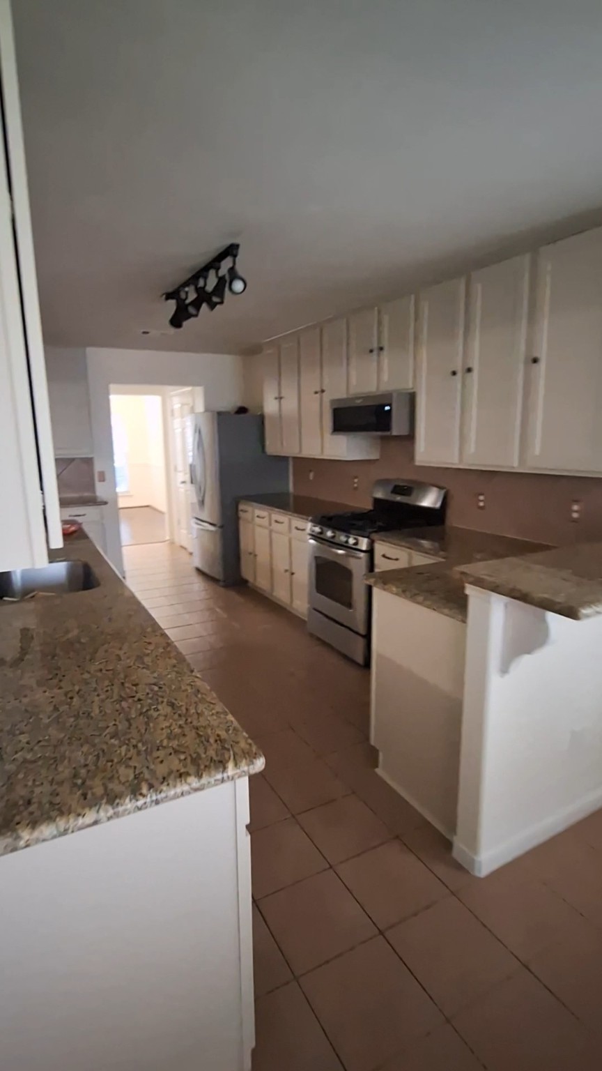 4507 Bridgestone Point Drive Spring, TX 77389 - Photo 5 of 21 a kitchen with stainless steel appliances granite countertop a sink stove and cabinets