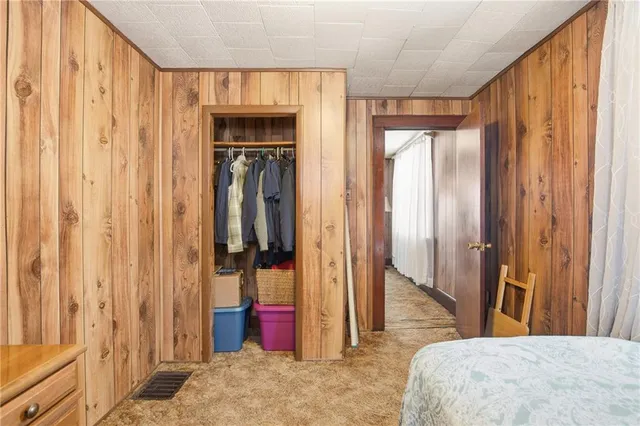 a bedroom with a bed and a mirror