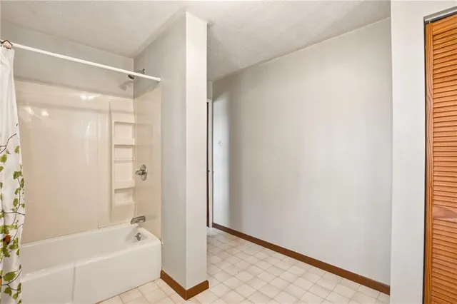 a bathroom with a bathtub and a shower