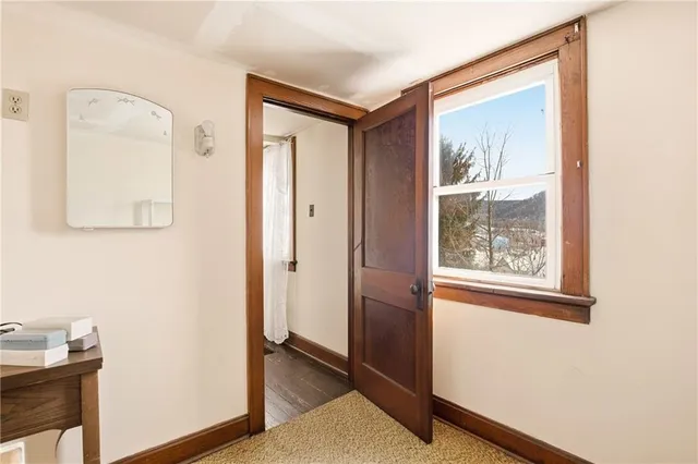 a view of an entryway with wooden floor