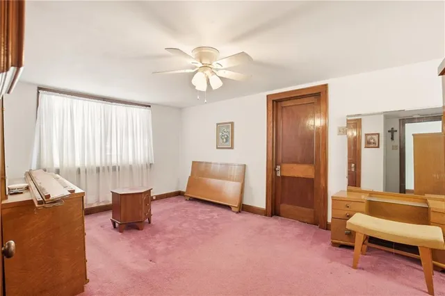 a living room with furniture and a dresser