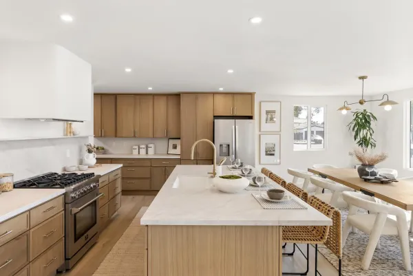a kitchen with kitchen island granite countertop a white cabinets and stove