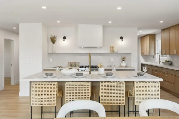 a view of a kitchen with granite countertop stainless steel appliances sink stove and cabinets