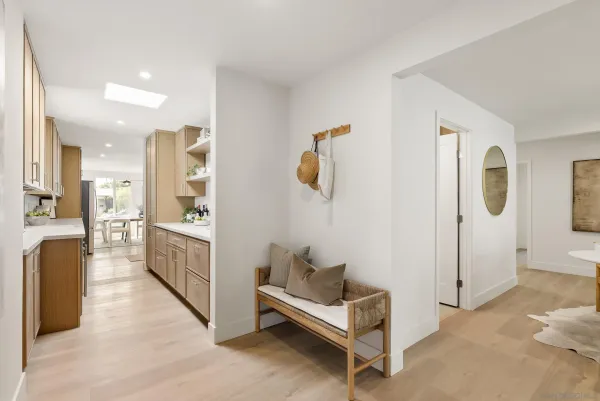 a view of a hallway with bathroom and wooden floor