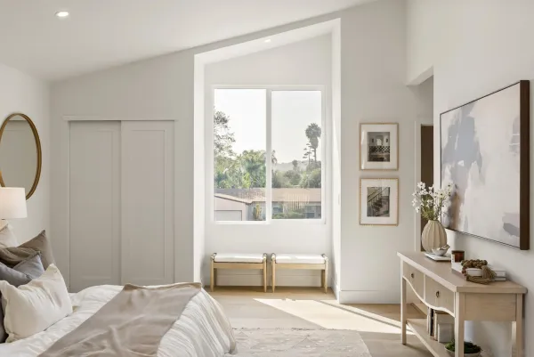 a bedroom with a bed and a window