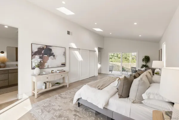 a spacious bedroom with a large bed and a window