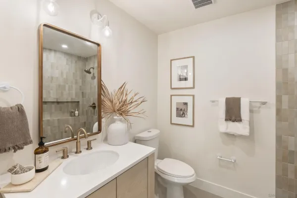 a bathroom with a sink a toilet and mirror