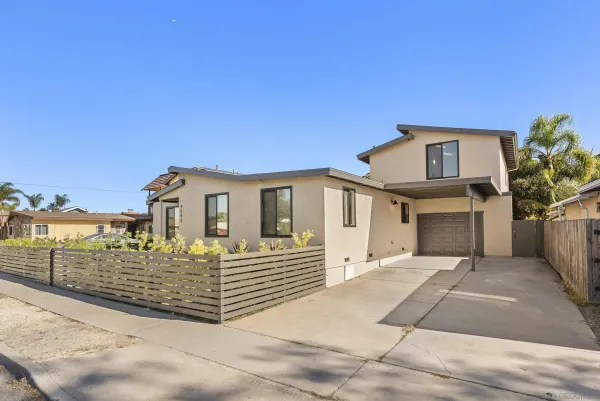 a front view of a house with a fence