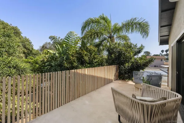 a balcony with wooden floor and outdoor space