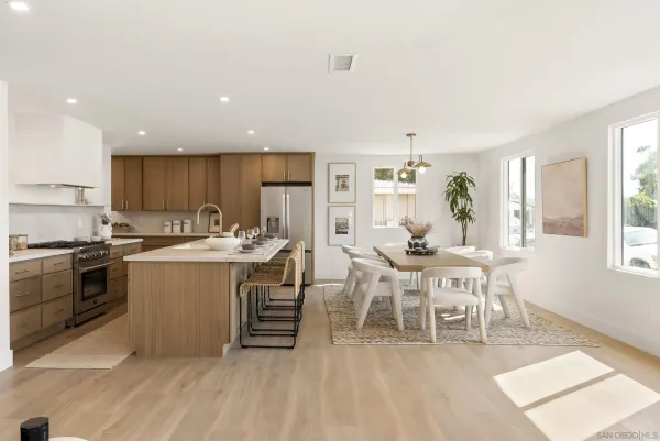 a kitchen with a sink and chairs